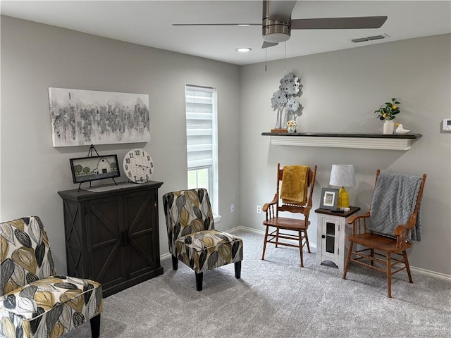 sitting room featuring carpet floors and ceiling fan