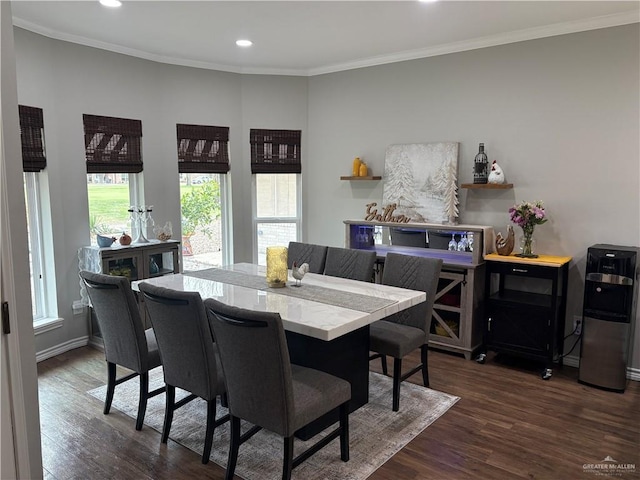 dining space with ornamental molding and dark hardwood / wood-style floors