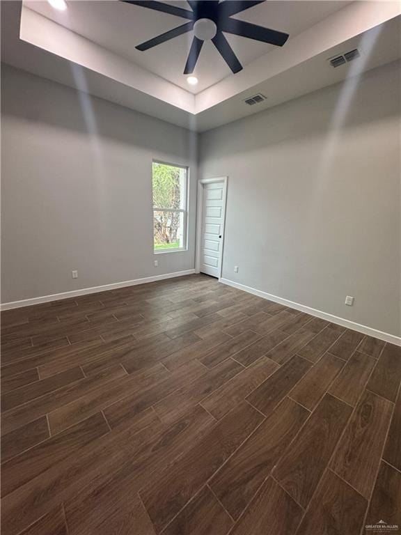 spare room with visible vents, ceiling fan, baseboards, and wood tiled floor