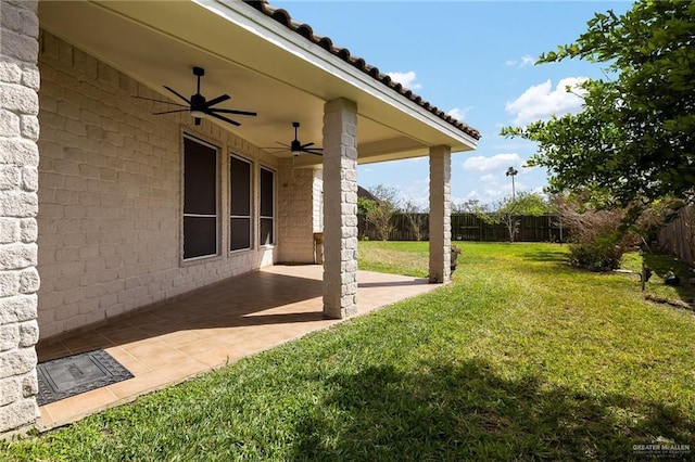 view of yard featuring ceiling fan, a patio area, and a fenced backyard