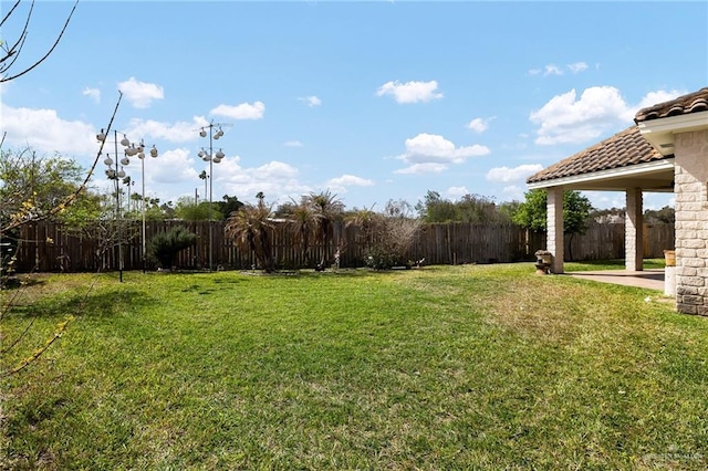 view of yard with a fenced backyard