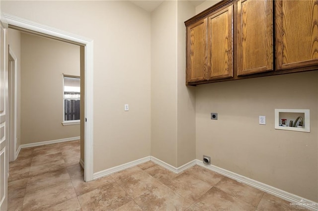 washroom featuring cabinet space, baseboards, washer hookup, and hookup for an electric dryer