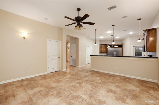 unfurnished living room featuring ceiling fan, visible vents, and baseboards