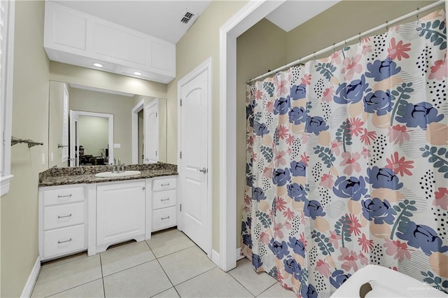 bathroom featuring tile patterned floors, vanity, and curtained shower