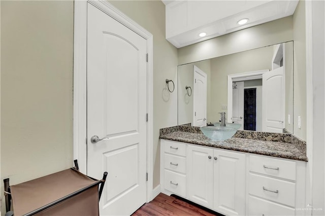 bathroom with vanity and wood-type flooring