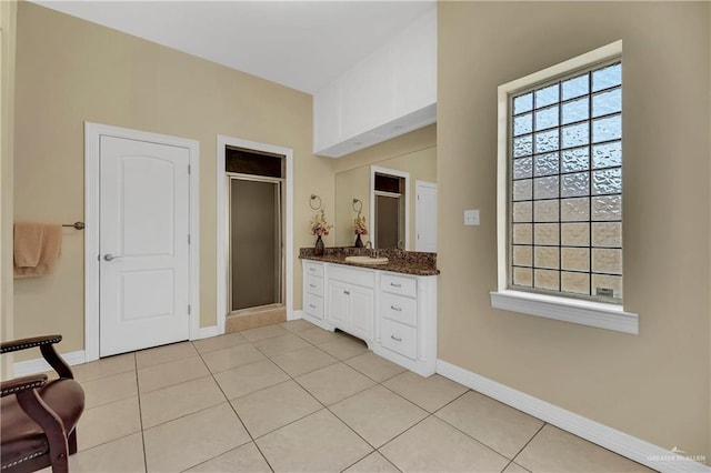 bathroom featuring vanity, tile patterned floors, and a shower with shower door