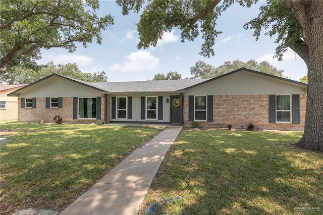1409 Pine Ct, Harlingen, TX 78550 - ranch-style home with brick siding and a front yard