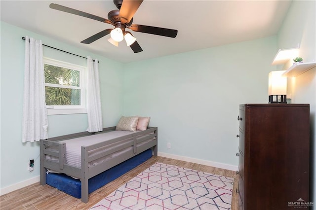 1409 Pine Ct, Harlingen, TX 78550 - bedroom with light wood-style floors and ceiling fan