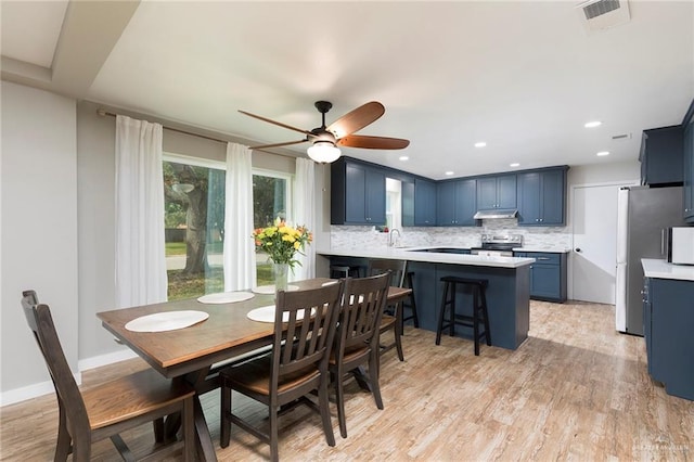 1409 Pine Ct, Harlingen, TX 78550 - dining space with light wood-style floors, ceiling fan, and recessed lighting