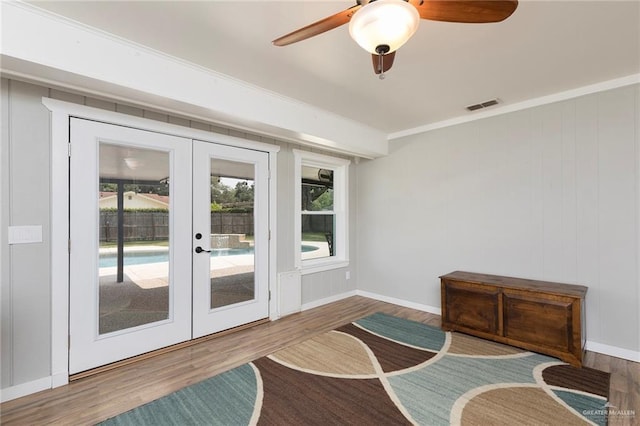 1409 Pine Ct, Harlingen, TX 78550 - living area featuring french doors, wood finished floors, a ceiling fan, and ornamental molding