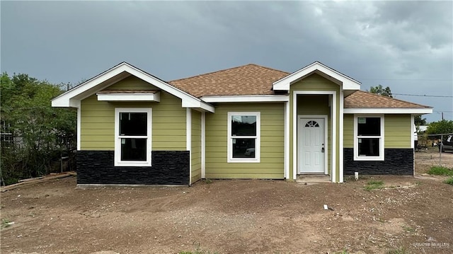 7512 S Naranja Ln, Pharr, TX 78577 - view of front facade featuring a shingled roof and stone siding