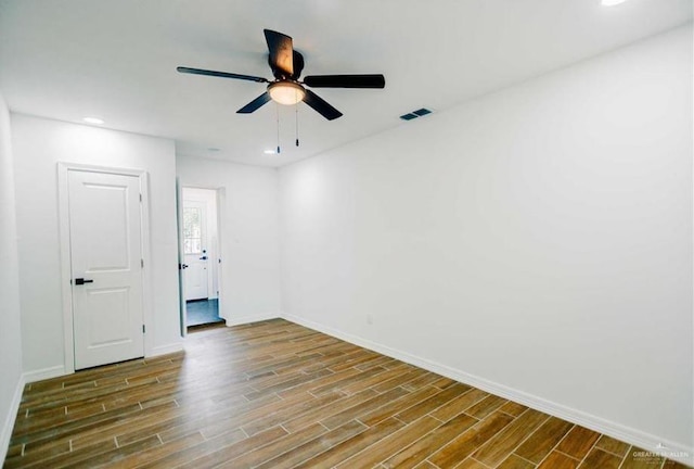 spare room featuring wood-type flooring and ceiling fan