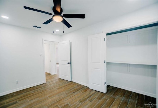 unfurnished bedroom with hardwood / wood-style floors, ceiling fan, and a closet