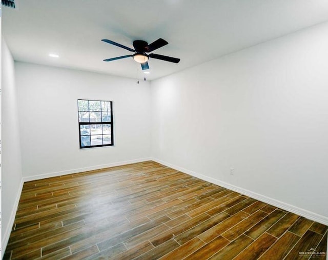 empty room with ceiling fan and dark hardwood / wood-style floors