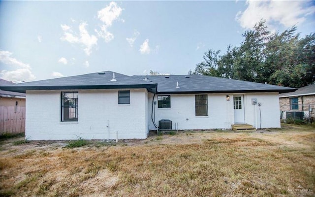 rear view of property featuring a yard