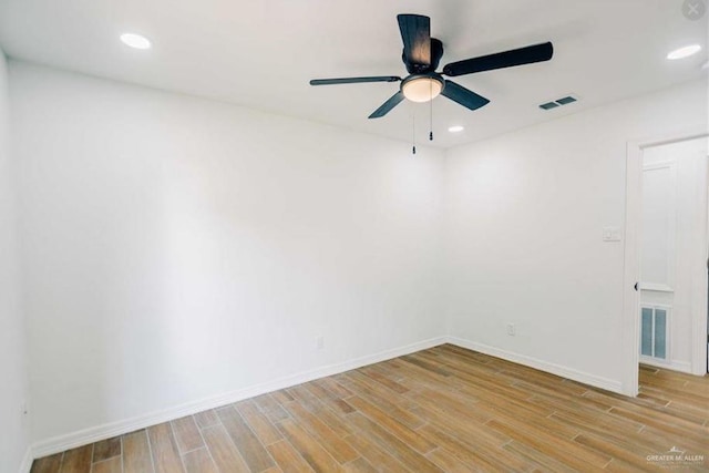 empty room featuring ceiling fan and light wood-type flooring