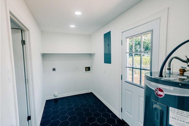 laundry area with electric dryer hookup, water heater, dark tile patterned floors, electric panel, and hookup for a washing machine