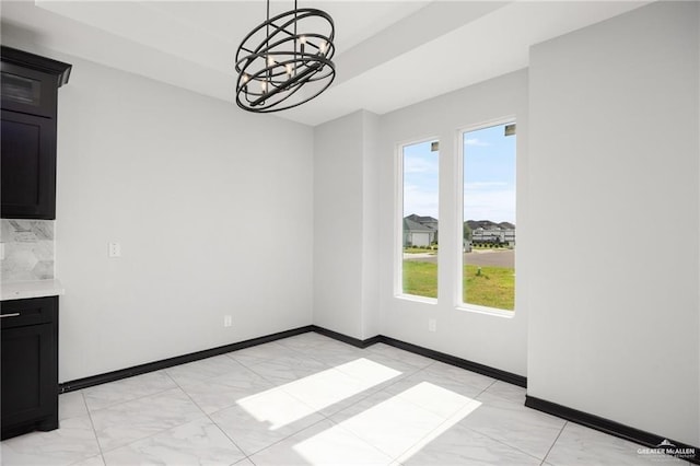 unfurnished dining area with a chandelier