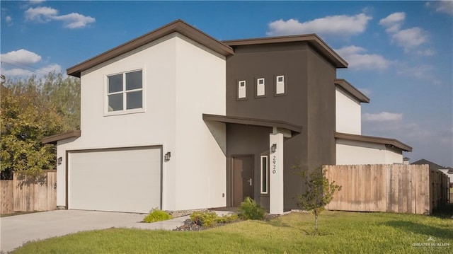 view of front of home with a garage and a front yard