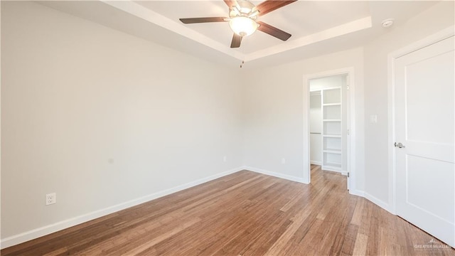 empty room with ceiling fan and light hardwood / wood-style floors