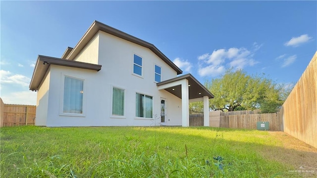 back of house with a yard