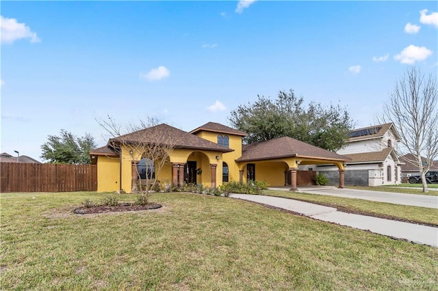 view of front of property with a front yard, fence, and stucco siding