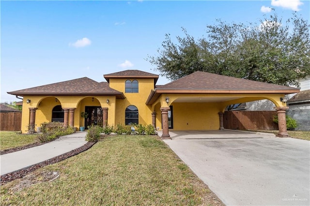 view of front of house featuring concrete driveway, a carport, a front yard, and stucco siding