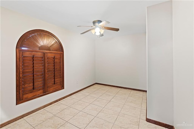 unfurnished room featuring light tile patterned floors, ceiling fan, and baseboards