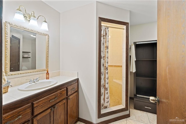 bathroom with a stall shower, tile patterned flooring, and vanity