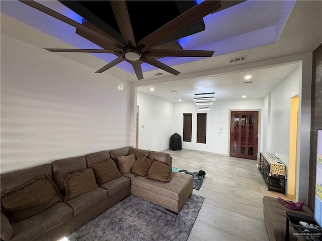 living area featuring heating unit, visible vents, and recessed lighting