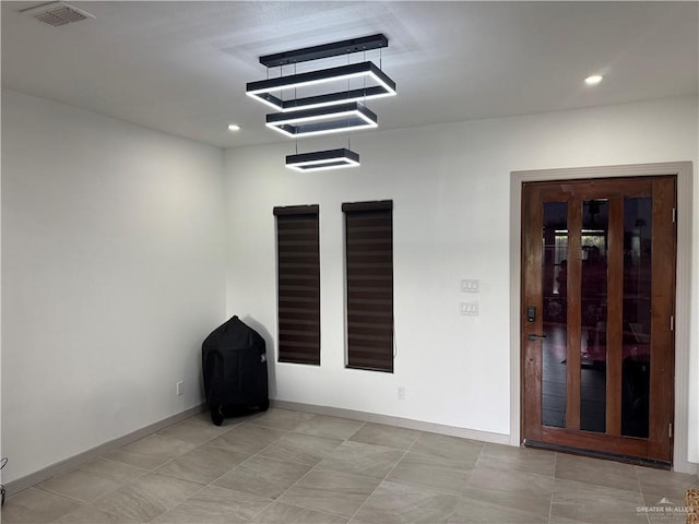 unfurnished room with recessed lighting, visible vents, and baseboards