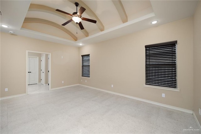 empty room featuring vaulted ceiling with beams and ceiling fan