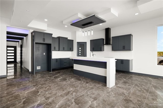 509 Demi St, Edinburg, TX 78542 - kitchen with a sink, wall chimney exhaust hood, a center island with sink, light countertops, and recessed lighting