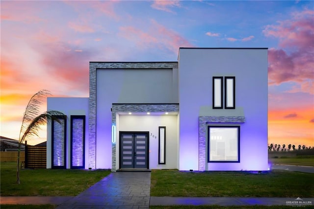 509 Demi St, Edinburg, TX 78542 - contemporary house featuring stucco siding, a front lawn, and stone siding