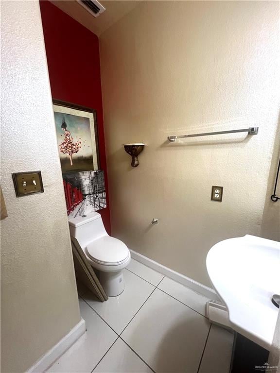 bathroom with tile patterned flooring, toilet, and sink