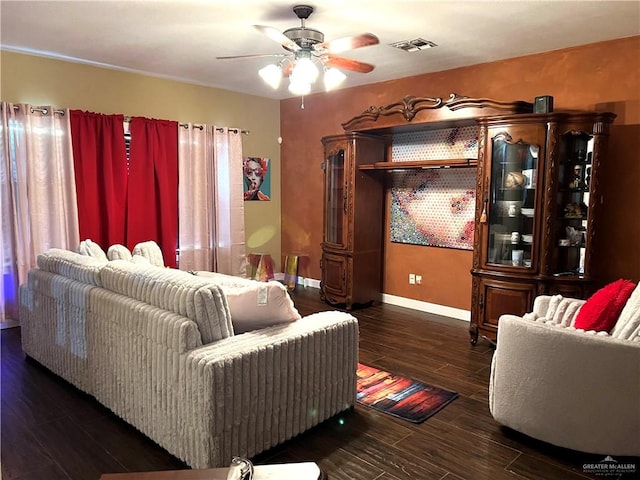 living room with ceiling fan and dark wood-type flooring