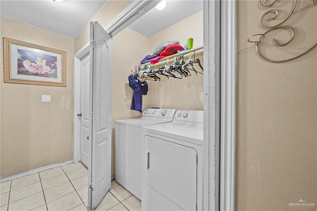 laundry room featuring separate washer and dryer and light tile patterned flooring