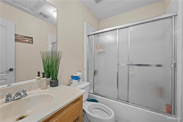 full bathroom featuring vanity, toilet, and combined bath / shower with glass door