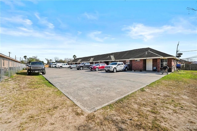 view of vehicle parking with a lawn