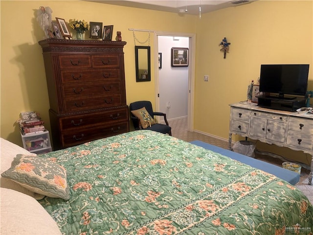 bedroom with visible vents and baseboards