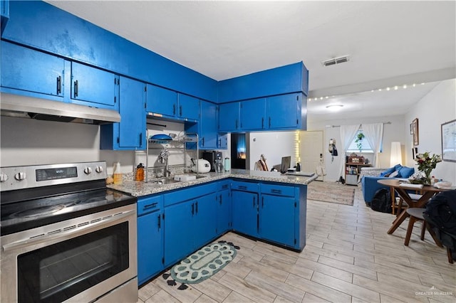 kitchen featuring blue cabinetry, stainless steel electric range oven, under cabinet range hood, and a sink