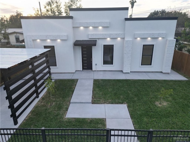 view of front of home featuring a yard and a patio area