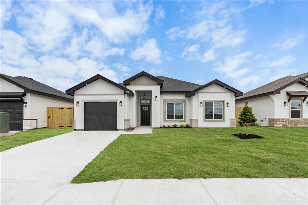 view of front facade featuring a front lawn and a garage