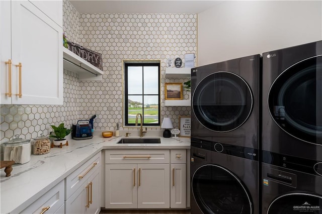 4825 Estancia Pkwy, Mcallen, TX 78504 - laundry area featuring stacked washer and clothes dryer and cabinet space