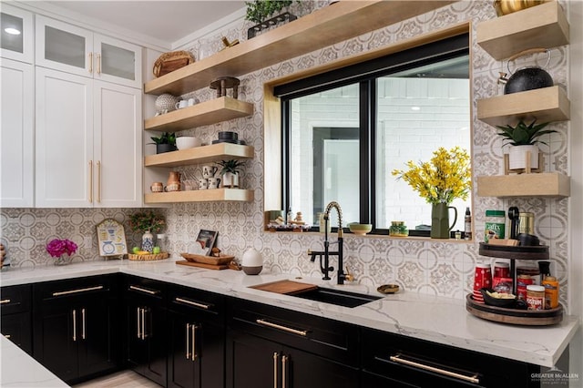 4825 Estancia Pkwy, Mcallen, TX 78504 - kitchen featuring open shelves, a sink, dark cabinets, white cabinetry, and backsplash