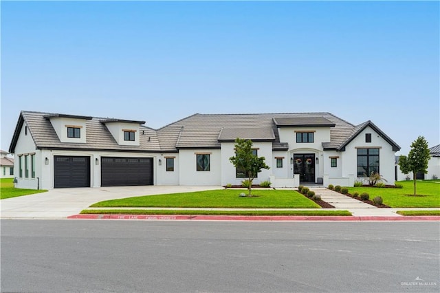 4825 Estancia Pkwy, Mcallen, TX 78504 - view of front facade with a front lawn, driveway, stucco siding, and a garage
