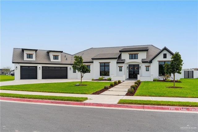 4825 Estancia Pkwy, Mcallen, TX 78504 - modern farmhouse featuring concrete driveway, a front yard, a garage, and stucco siding