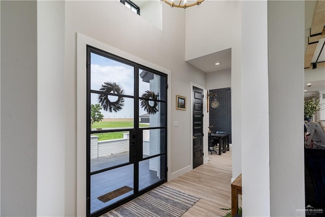 4825 Estancia Pkwy, Mcallen, TX 78504 - doorway to outside with light wood-style flooring, a chandelier, and baseboards