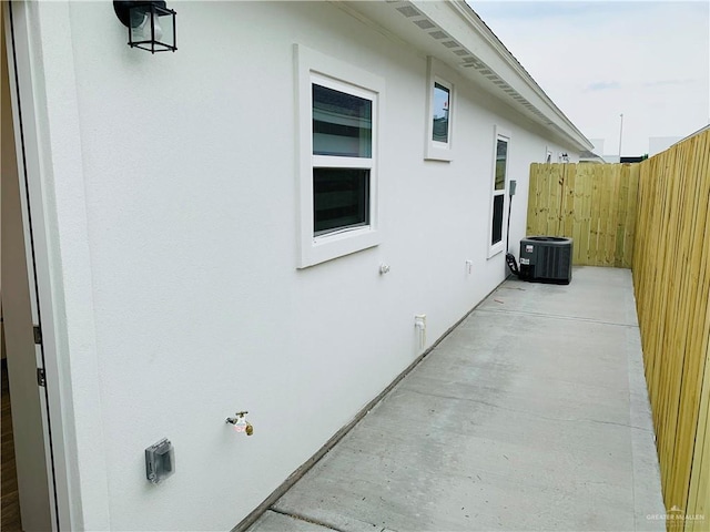 view of side of property featuring a patio and central air condition unit