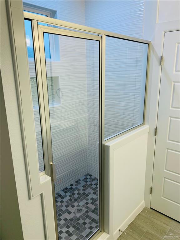 bathroom featuring a shower with door